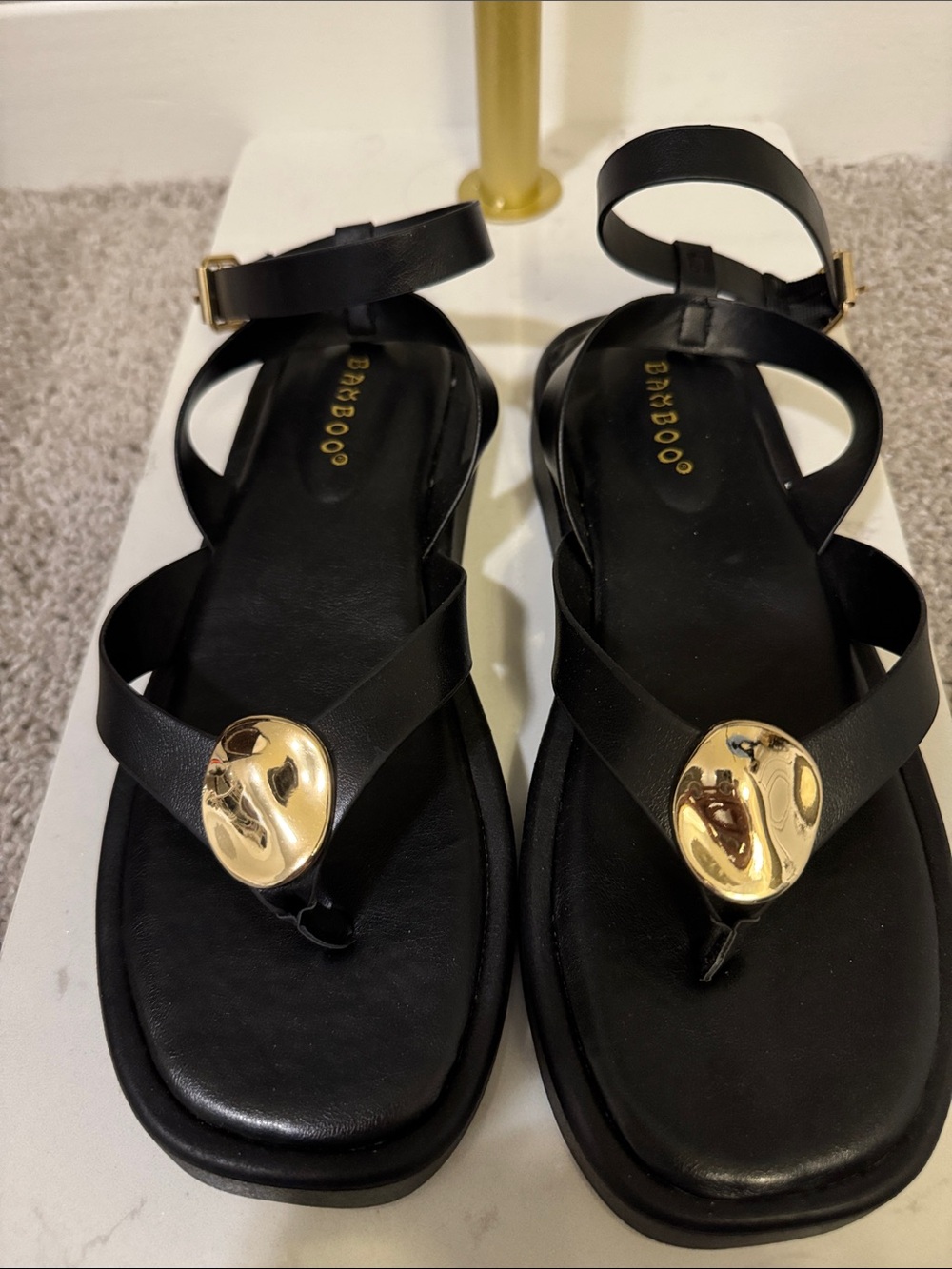 BAMBOO Black Ankle-Strap Sandals with Gold Medallion Accent